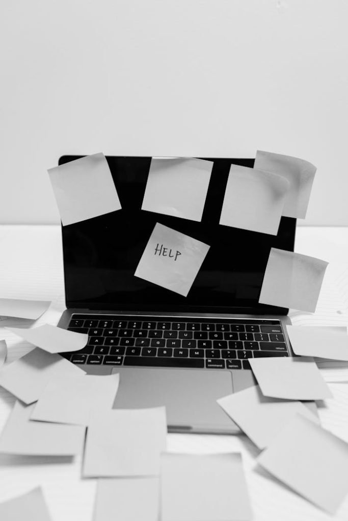 laptop-with-sticky-notes-8386748 Black and white photo of a laptop covered with sticky notes, one labeled HELP.